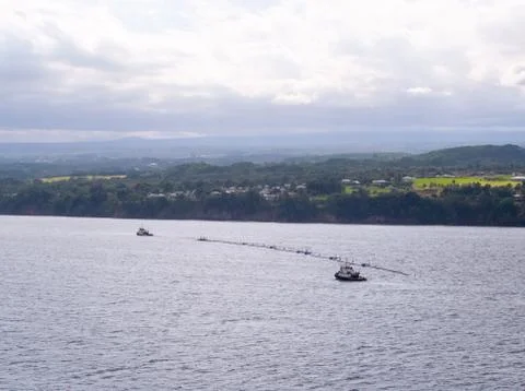 An offshore floating device to capture plastic is in Hilo Hawaii for repairs. Stock Photos