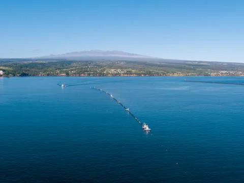 An offshore floating device to capture plastic is in Hilo Hawaii for repairs. Stock Photos
