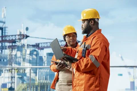 Offshore installation manager and worker manage maintenance systems Stock Photos