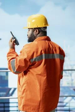 Offshore installation manager communicates with crew through portable radio Stock Photos