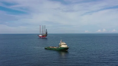 Offshore jack-up drilling rig and a standby vessel Stock Footage 115404387