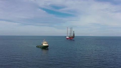 Offshore jack-up drilling rig and a standby vessel Stock Footage 115404434
