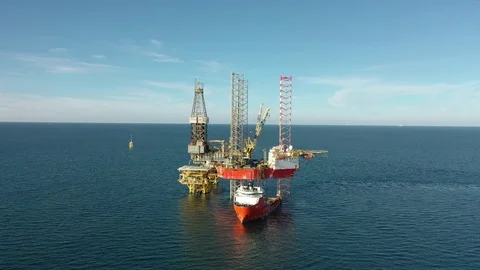 Offshore jack-up drilling rig and a standby vessel Stock Footage 117390808