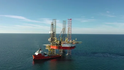 Offshore jack-up drilling rig and a standby vessel Stock Footage 117391390