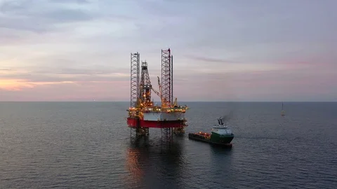 Offshore jack-up drilling rig and a standby vessel Stock Footage 117974694