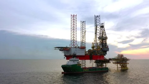 Offshore jack-up drilling rig and a standby vessel Stock Footage 117997224