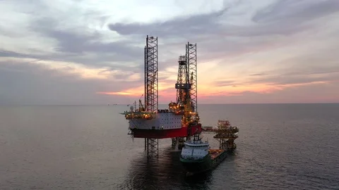 Offshore jack-up drilling rig and a standby vessel Stock Footage 118043097