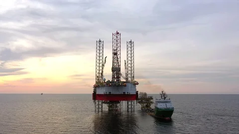 Offshore jack-up drilling rig and a standby vessel Stock Footage 118065341