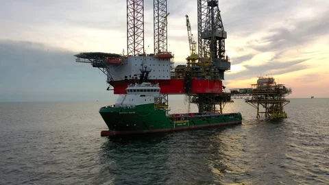 Offshore jack-up drilling rig and a standby vessel Stock Footage 118104636