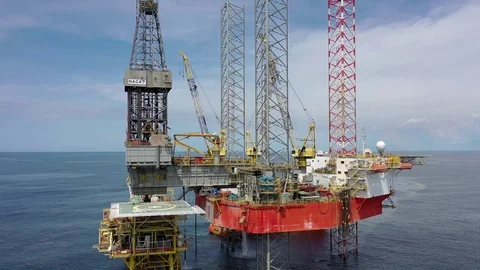 Offshore jack-up drilling rig and a standby vessel Stock Footage 118369946
