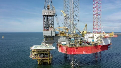 Offshore jack-up drilling rig and a standby vessel Stock Footage 119704673