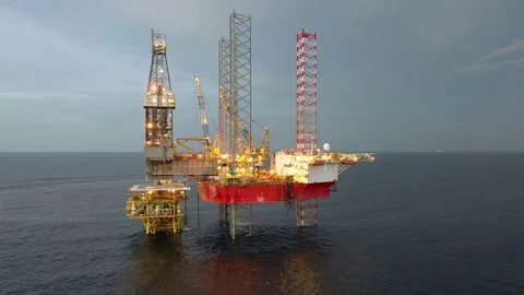 Offshore jack-up drilling rig during sunset Stock Footage 118570493