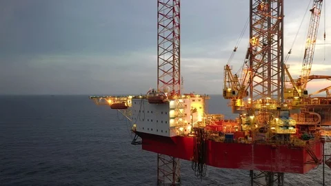 Offshore jack-up drilling rig during sunset Stock Footage 118638864