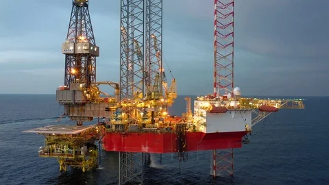 Offshore jack-up drilling rig during sunset Stock Footage 118655950