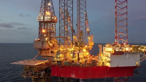 Offshore jack-up drilling rig during sunset Stock Footage 119707768