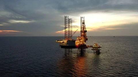 Offshore jack-up drilling rig during sunset Stock Footage 119711506
