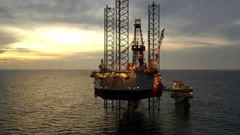 Offshore jack-up drilling rig during sunset Stock Footage 119711522