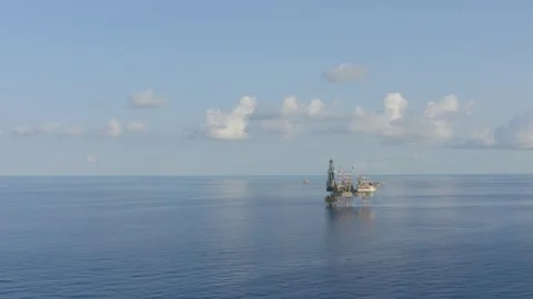 Offshore Jack up drilling rig in the middle of the ocean on sunny day Stock Footage 299261020