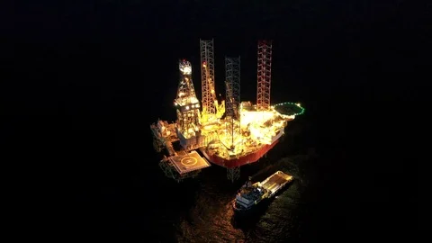 Offshore jack-up drilling rig at night Stock Footage 119621297