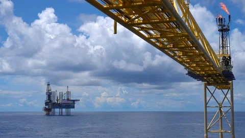 Offshore jack up drilling rig at the offshore location with flare bridge of prod Stock Footage 145972918