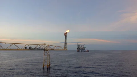 Offshore jack up drilling rig at the offshore location with flare bridge of prod Stock Footage 145972942