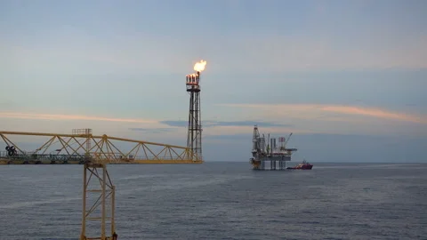 Offshore jack up drilling rig at the offshore location with flare bridge of prod Stock Footage 146336296