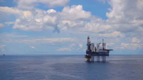 Offshore jack up drilling rig at the offshore location with flare bridge of prod Stock Footage 153918179