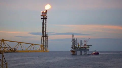 Offshore jack up drilling rig at the offshore location with flare bridge of prod Stock Footage 153923800