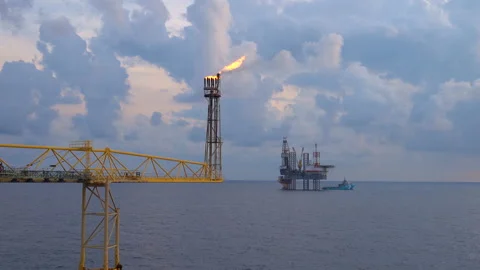 Offshore jack up drilling rig at the offshore location with flare bridge of prod Stock Footage 155221709