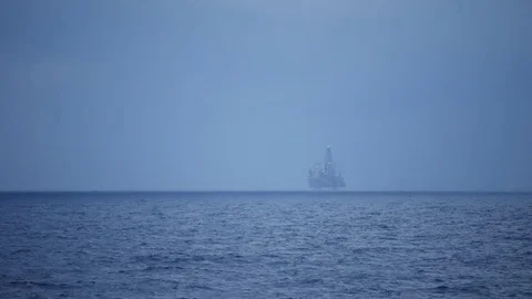 Offshore Jack up drilling rig in stormy clouds over dark ocean and raining Stock Footage 74779510