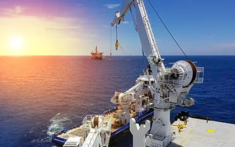 Offshore lifting operations at sea between two ships Stock Photos