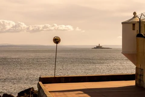 Offshore lighthouse viewed from Cascais harbor viewpoint Stock Photos