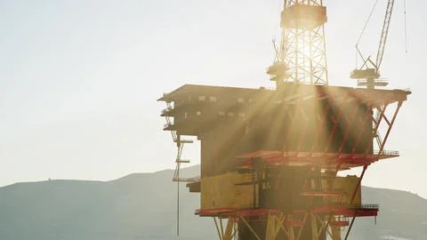 An offshore oil platform at sunset light Stock Illustration