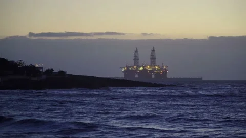 Offshore Oil Rig Drilling Platform in the ocean at the dusk. 4K Video Clip Free Stock Footage 92385454