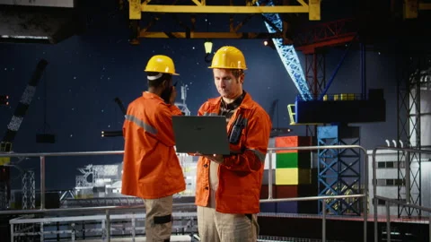 Offshore oil rig engineer evaluate system performance using digital apps Stock Footage 324705059