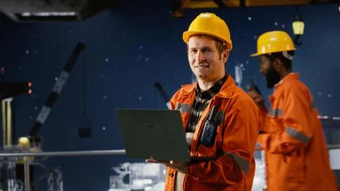 Offshore oil rig engineer evaluate system performance using digital apps Stock Photos