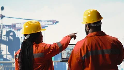 Offshore platform employees use management software to observe operations Stock Photos