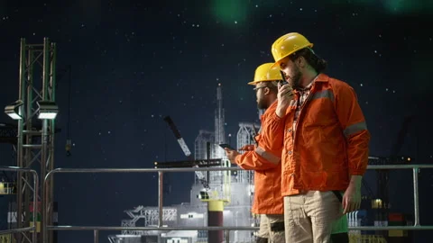 Offshore platform engineer provides updates over walkie talkie during oil crisis Stock Footage 336195585