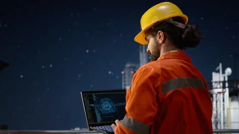 Offshore platform engineering team uses AI on laptop monitoring operations Stock Footage 336201313
