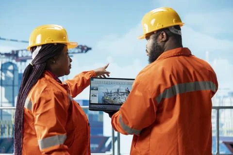 Offshore platform engineering team using laptop software interface Stock Photos
