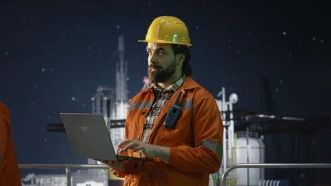Offshore platform installation manager managing systems using laptop Stock Photos