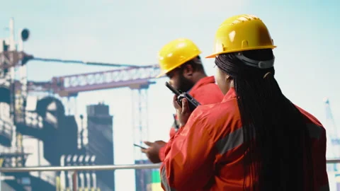 Offshore platform worker speaking in walkie talkie, testing safety system Stock Footage 319970582