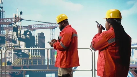 Offshore platform worker speaking in walkie talkie, testing safety system Stock Footage 319974648