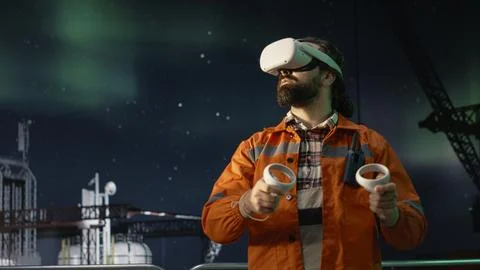 Offshore platform workers using VR headset to monitor fuel shortages 스톡 사진