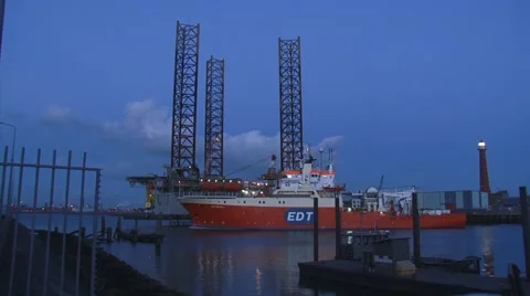 Offshore research/survey and dive support vessel EDT Protea passes Jackup rig Stock Footage 47503575