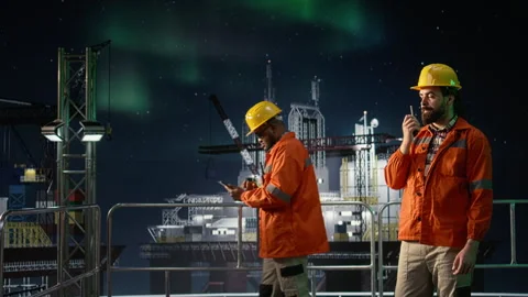 Offshore rig engineer speaking in walkie talkie during global oil crisis Stock Footage 336196060