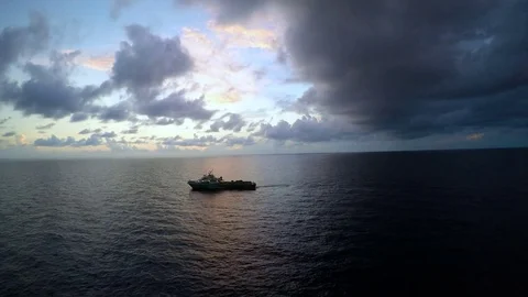 Offshore sunrise with crew boat and raining at the end Stock Footage 80482268