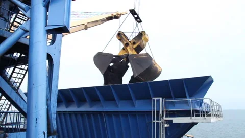 Offshore transfer of coal from barges to cargo ships Stock Footage 147658748