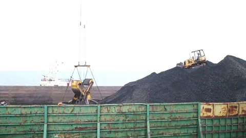 Offshore transfer of coal from barges to cargo ships Stock Footage 147659097