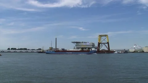 Offshore transformator platform moves across waterway + skyine fruit harbour Stock Footage 144616571
